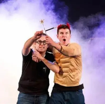 Performers at the Potted Potter show holding a book