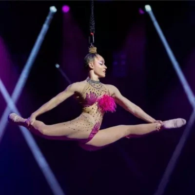 Aerial performer doing a split mid-air at Mad Apple, Las Vegas.