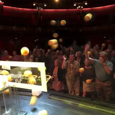 Audience throwing yellow foam balls during the Mentalist show in Las Vegas
