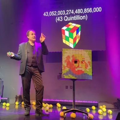 Gerry McCambridge performing a trick with a Rubik’s cube during The Mentalist show