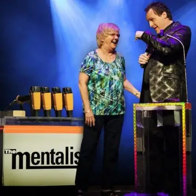 Gerry performing a trick with an old lady at The Mentalist show