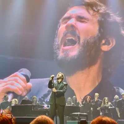 Josh Groban performing in front of a Piano