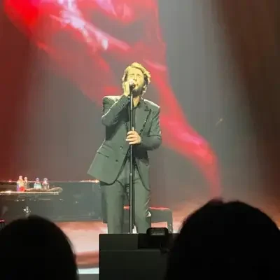 Groban singing in front of a piano