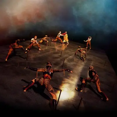 A group of performers from Cirque du Soleil's performing the battle on the sand cliff deck stage.