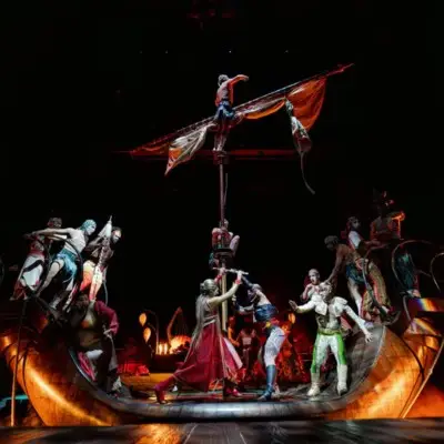 A dramatic scene from Cirque du Soleil's KÀ, featuring performers on and around a large boat.