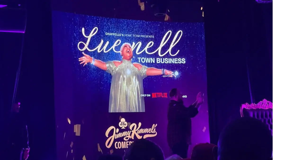 Luenell's picture projected on a screen in Las Vegas