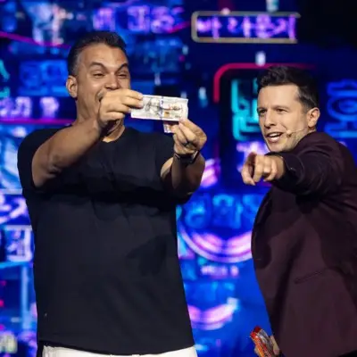 Mat Franco performing a card trick with an audience