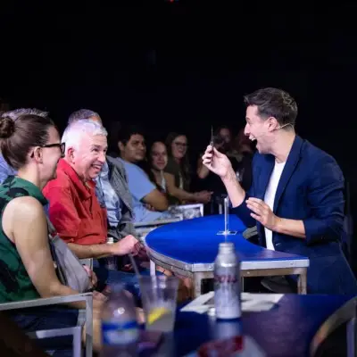 Mat Franco performing a trick with a senior person