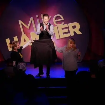 Mike Hammer performing a magic trick with his audience