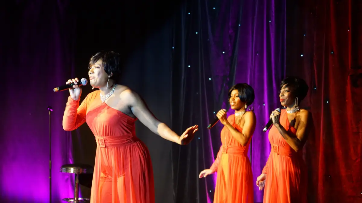 Four performers from Motown Brunch performing on stage at the Ahern Hotel