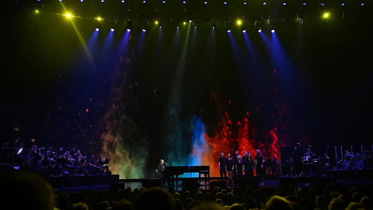 A picture of Josh Groban and choir performing in front of the audience