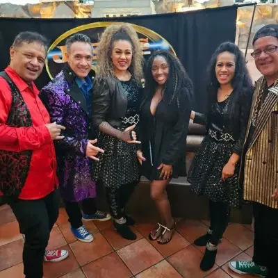 A female member of the group posing with fans