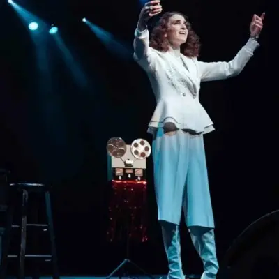 he Richard impersonator playing the piano while his sisters impersonator is singing