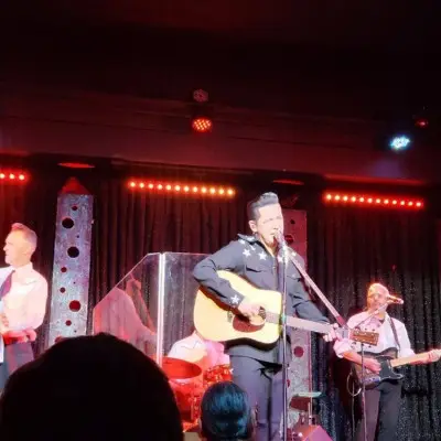 Cash After Dark performing while looking at the audience