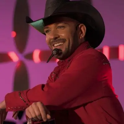 Chase Brown smiling at the audience while performing