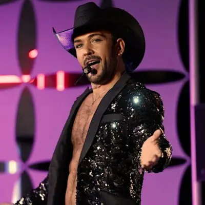 The main artist looking into the camera while performing in Las Vegas