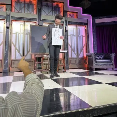 Colin with a picture in his hands at the Colin Cloud Mastermind show