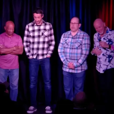 Comedian and audiences standing on stage