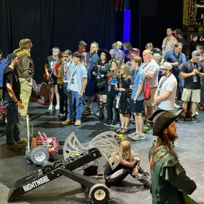 Contestants waiting with robots before a match at the BattleBots Arena