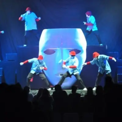 Dancers around a white mask in Jabbawockeez in Vegas