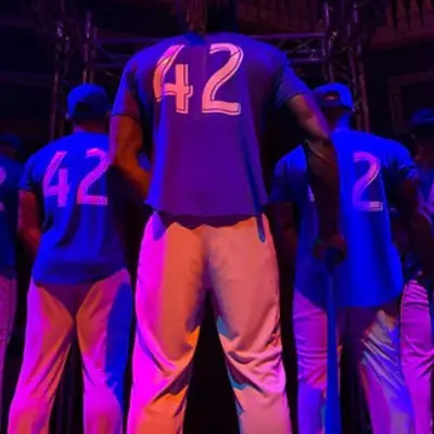 Dancers in baseball uniform for Black Magic Live