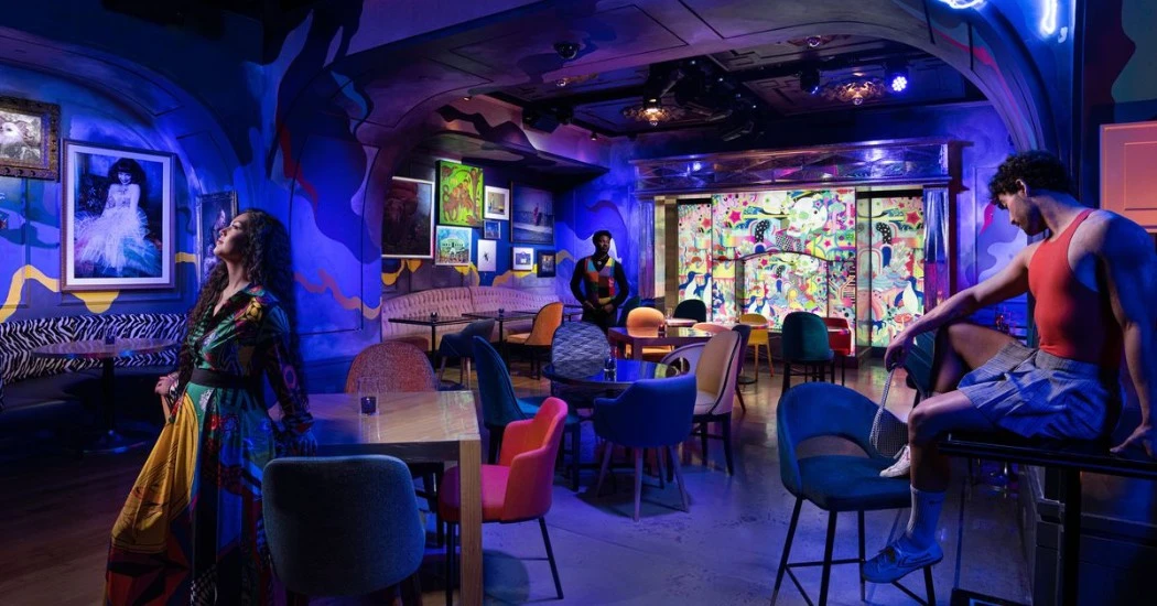 dinner vegas venue Vibrant dining and performance space with decor and neon lighting.