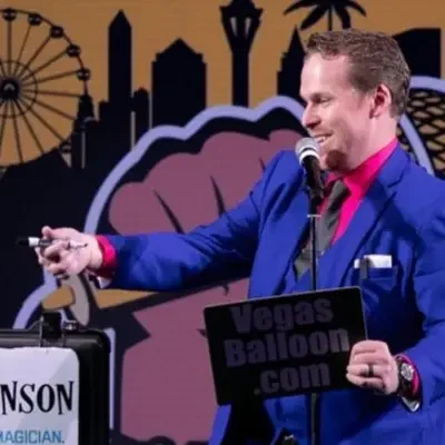 The artist holding a pen and a board while performing