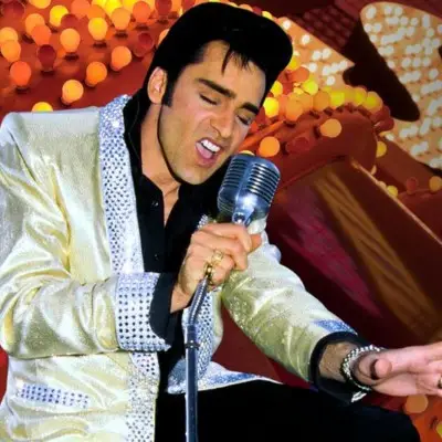 The Elvis impersonator posing with the audience in Las Vegas Elvis impersonator singing on stage in Las Vegas