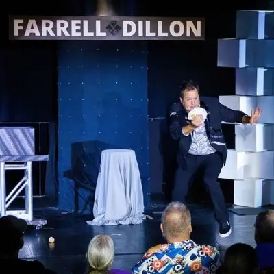 Farrell Dillon holding red foam balls in between his fingers