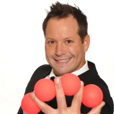 Farrell Dillon with cards in his hands at the Farrell Dillon Comedy Magic show