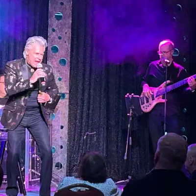 Frankie Valli impersonator singing on stage