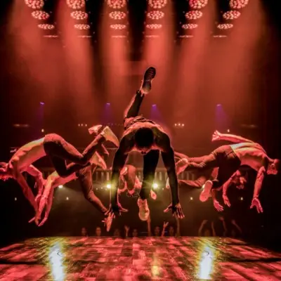 Group of dancers in the middle of a handstand in Magic Mike Live