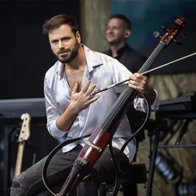 HAUSER playing his instrument with the main light falling on him