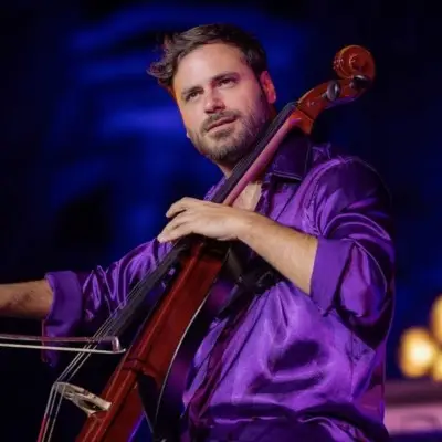 HAUSER wearing a purple shirt and performing