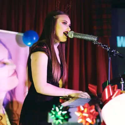 Julia playing the organ while singing