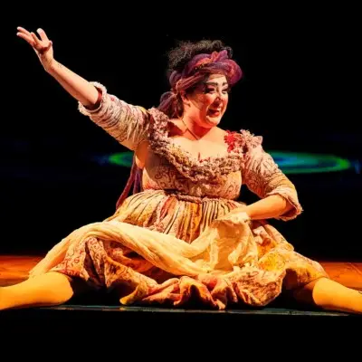 Female performer in colorful costume on stage at KÀ by Cirque du Soleil.