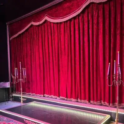 The stage decorated with a candelabra on the sides at the Las Vegas Magic Theate