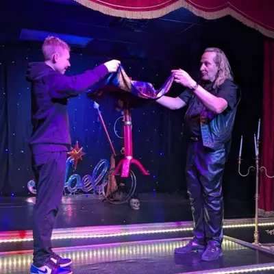 Losander making a table float at the Candlelight Magic Show at Vegas