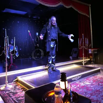 Losander making objects levitate at the Candlelight Magic Show