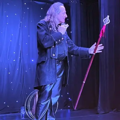 Losander performing magic with a red staff