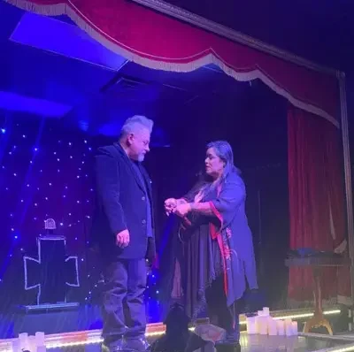 Luna Shimada performing tricks with audience member at the Witches and Warlocks show
