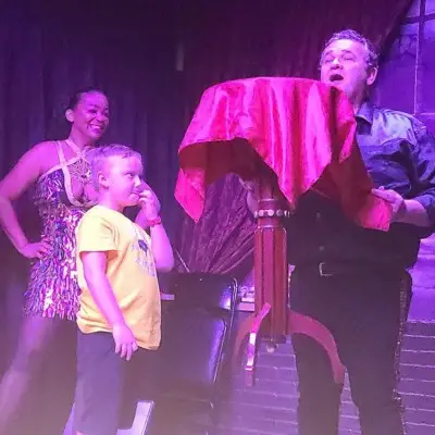 magician making a table float at the Magic Up Close show