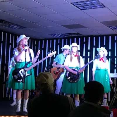 Mama’s Wranglers performing in Western-themed costumes