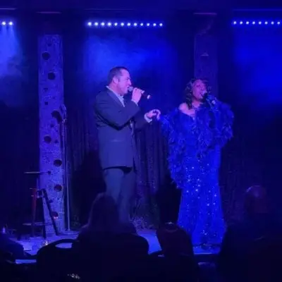 Two members of the show singing on stage in Las Vegas