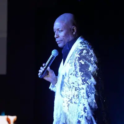 The main performer from Motown Brunch smiling at the audience