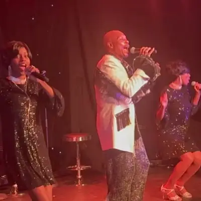 Four performers from Motown Brunch performing on stage at the Ahern Hotel
