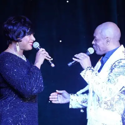 Two performers from Motown Brunch performing while facing each other