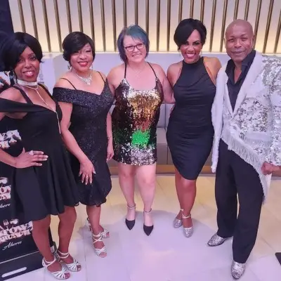 The performers of Motown Brunch posing with a fan