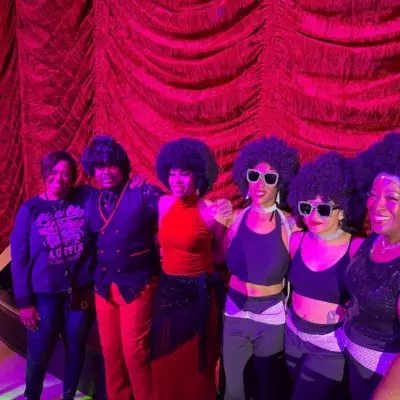 A member of Musical Journey With James Brown & Motown posing with fans