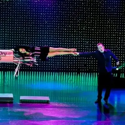 Nathan Burton performing tricks with an assistant